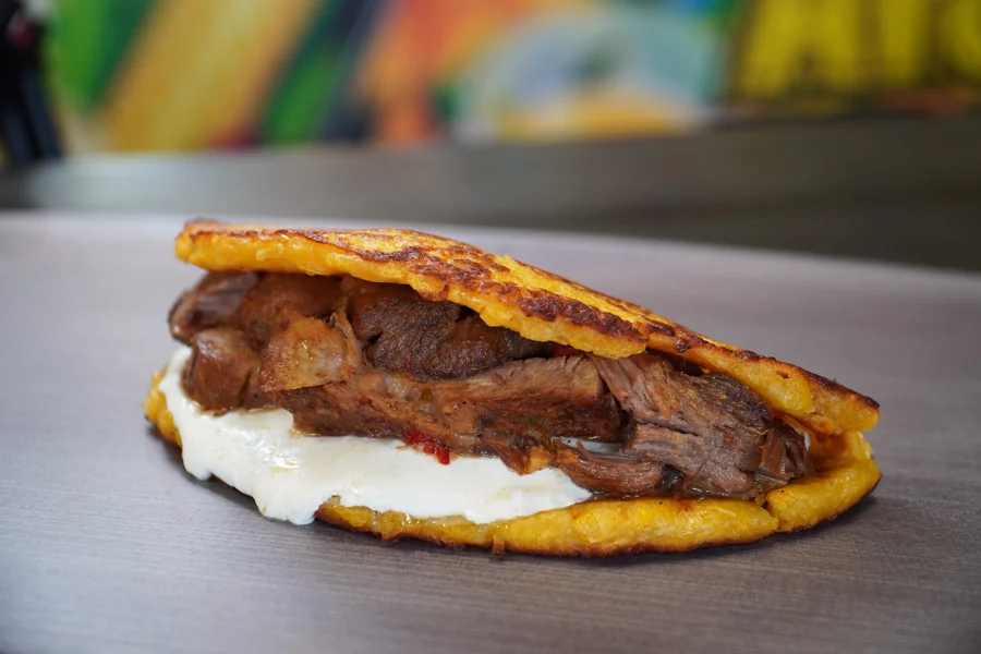 A sweet corn cachapa filled with meat and cheese